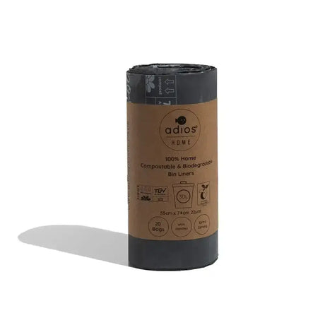 A roll of black adios compostable tie handle bin liners made from 100 percent home compostable biodegradable material