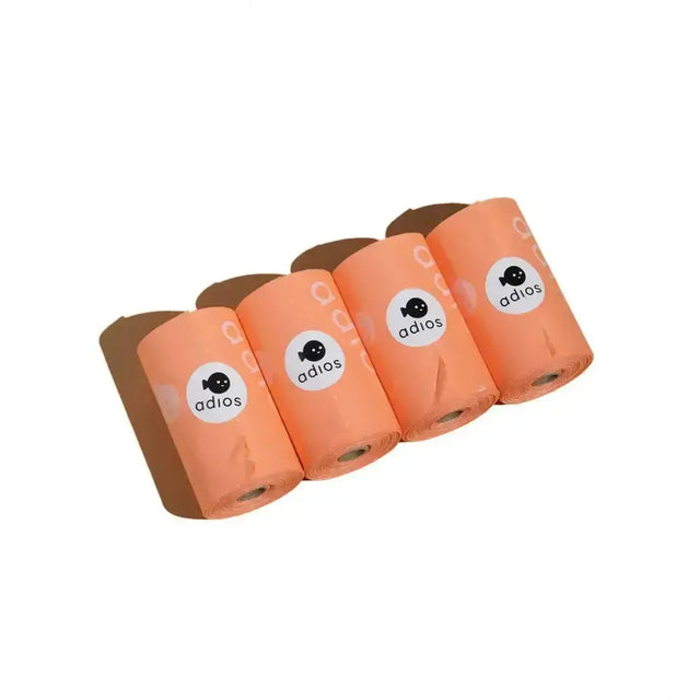 Four rolls of peach-colored adios non handle poo bags made of plastic for easy pet waste cleanup