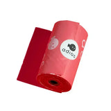 A roll of vibrant red glossy plastic adios non handle poo bags single roll with a white logo and cartoon fish design
