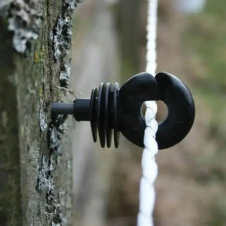 Black plastic rope guide with ring and spiral design on tree bark for agrifence maxicord braided rope smooth contact surface
