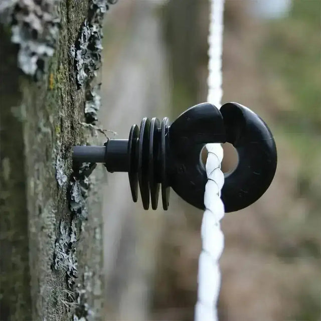 Black plastic rope guide with ring and spiral design on tree bark for agrifence maxicord braided rope smooth contact surface