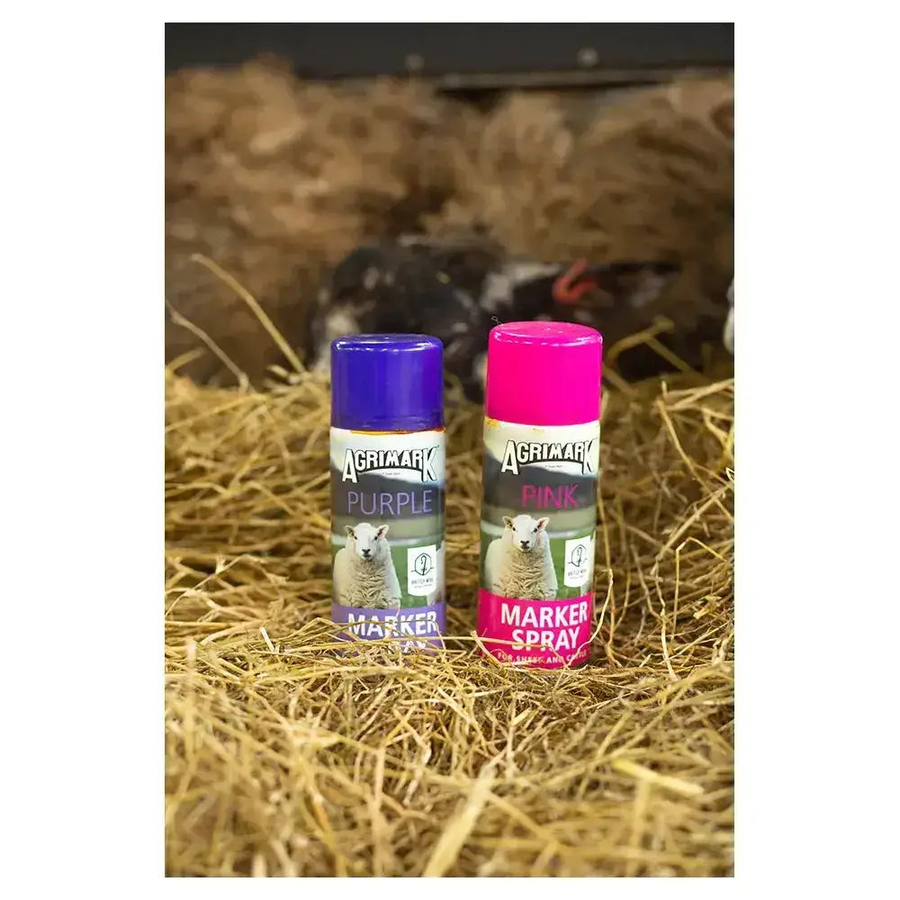 Two agrimark marker spray cans in purple and bright pink with sheep labels and a dispensing button for long lasting visible mark