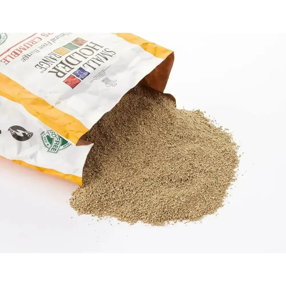 A bag of allen & page brown finely ground range layers crumble spilling on a white surface for free range layers