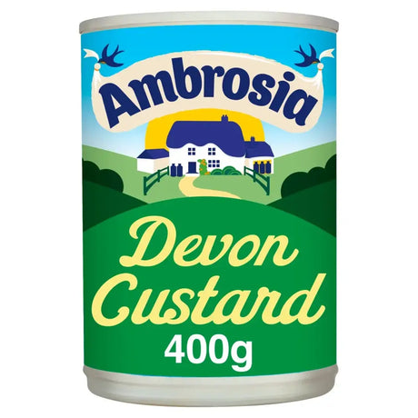 A 400g cylindrical tin of ambrosia devon custard with a green and blue label showing an illustrated countryside scene