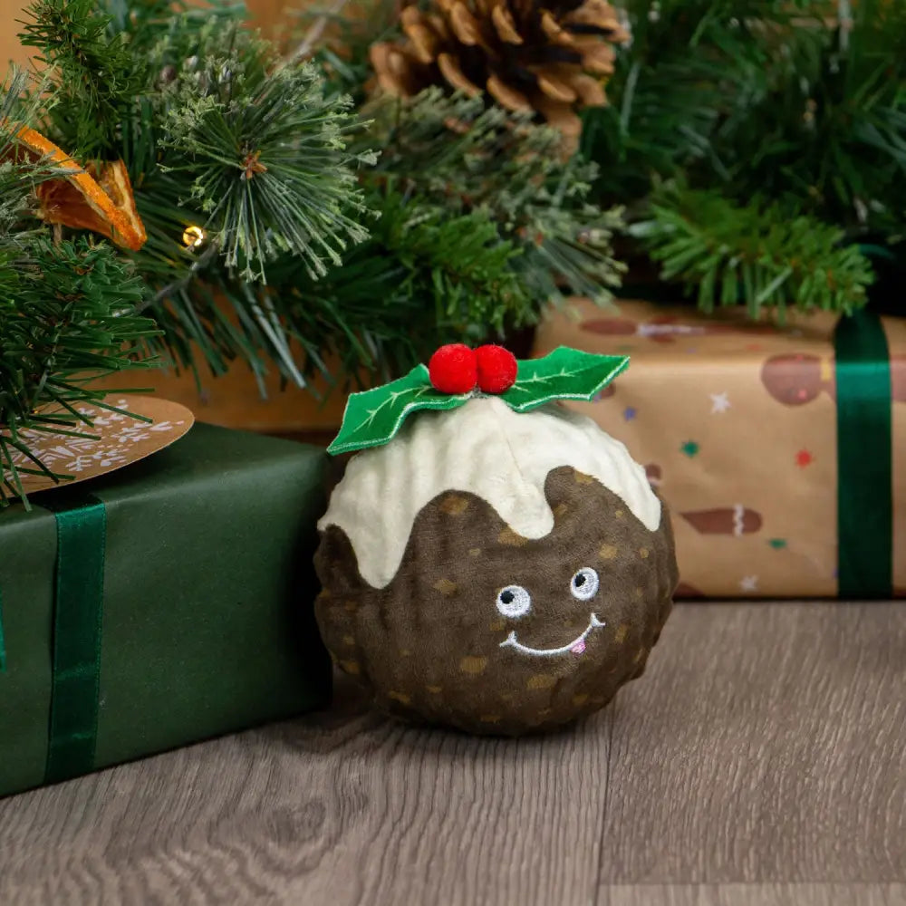 A plush brown christmas pudding toy with white icing and red holly berries from ancol bouncing colin junior