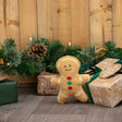 An ancol georgia gingerbread plush toy with tan fabric body and colorful red and green button details