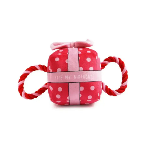 Pink plush ancol pawty time birthday present dog toy with polka dots and red white twisted rope handles