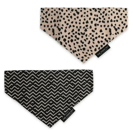 Two ancol pet bandana designs featuring beige dalmatian spots and bold black and white zig zag patterns for dogs