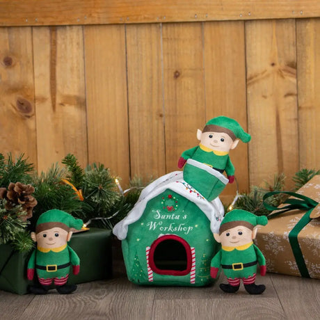 Green plush elf-themed pet house with white trim red candy cane accents labeled santa’s workshop for toy horses equestrian use