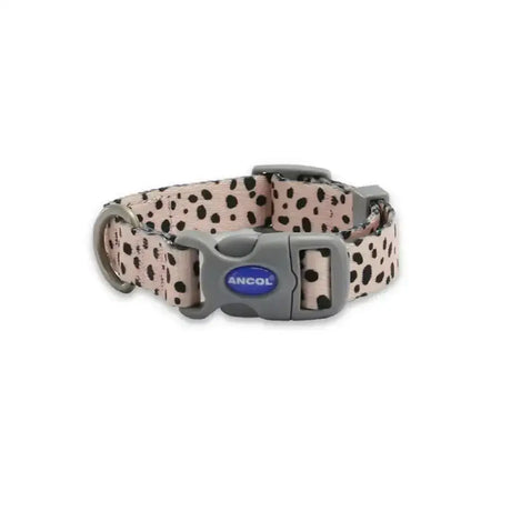 A pink ancol soho pet collar with black spots and a gray plastic buckle featuring a modern dalmatian pattern