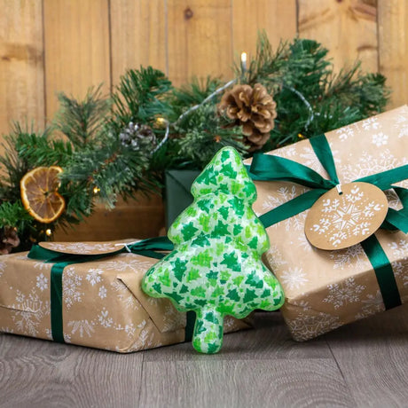 A green ancol squeaky christmas tree ornament made of ceramic with smaller tree patterns in varying green shades