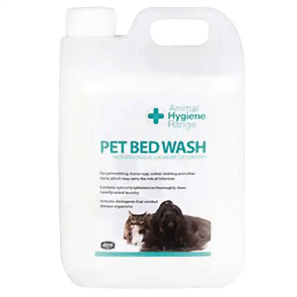 White plastic jug with handle and cap labeled pet bed wash by animal health company for heavily soiled laundry