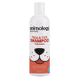 White plastic bottle of animology essentials flea and tick shampoo for dogs with cartoon dog face on orange label