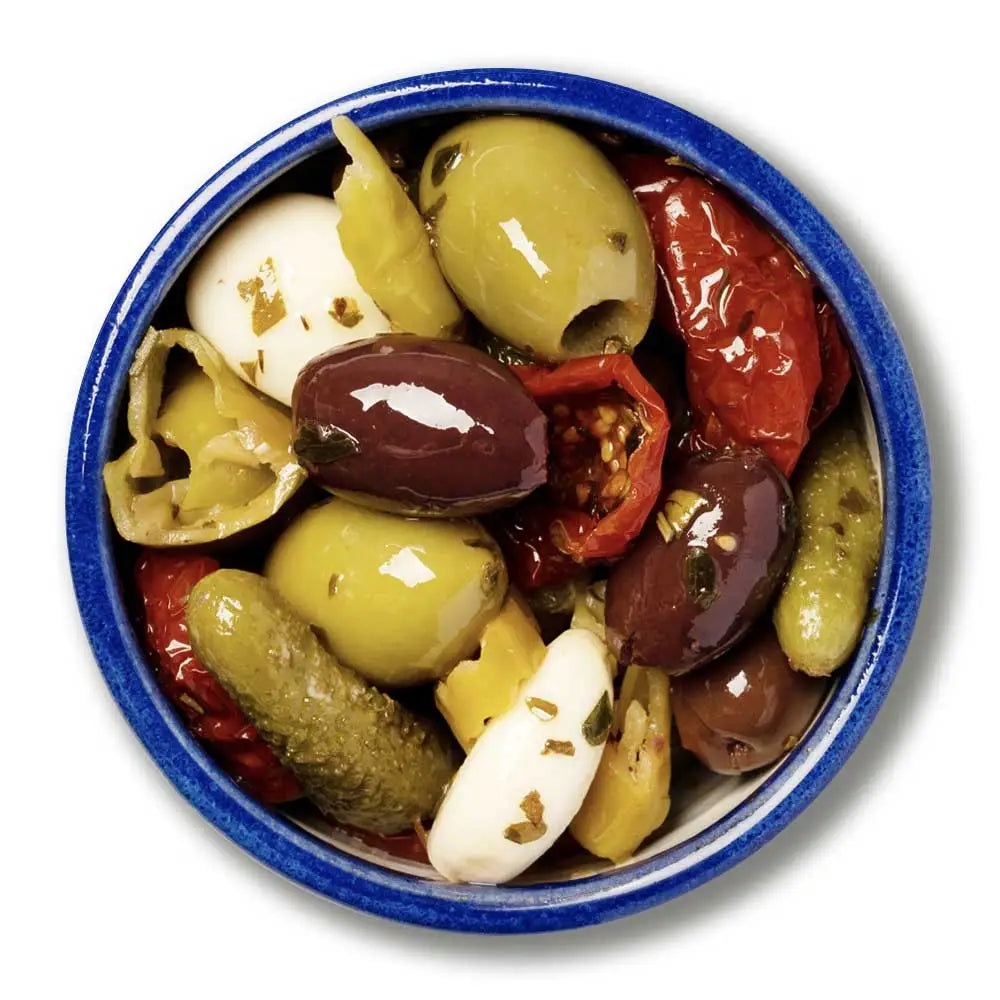 A vibrant rustic blue bowl filled with antipasti olives including stuffed green olives and green olives mix