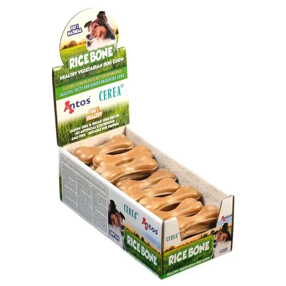 Tan bone-shaped rice dog chews in a green and white display box from antos cerea rice bone cerea range