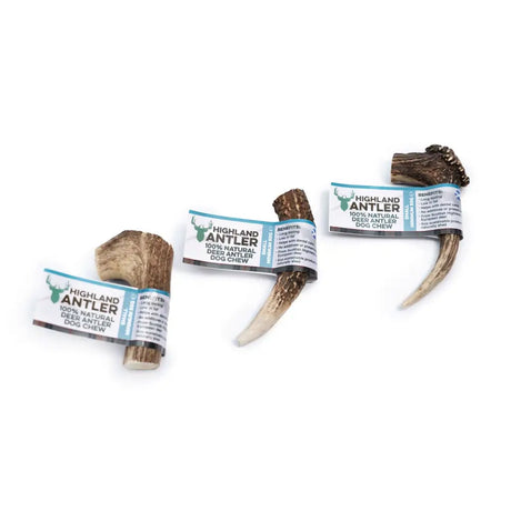 Three natural 100 percent highland antler dog chews in branded wrapping from antos highland with varied shapes and sizes