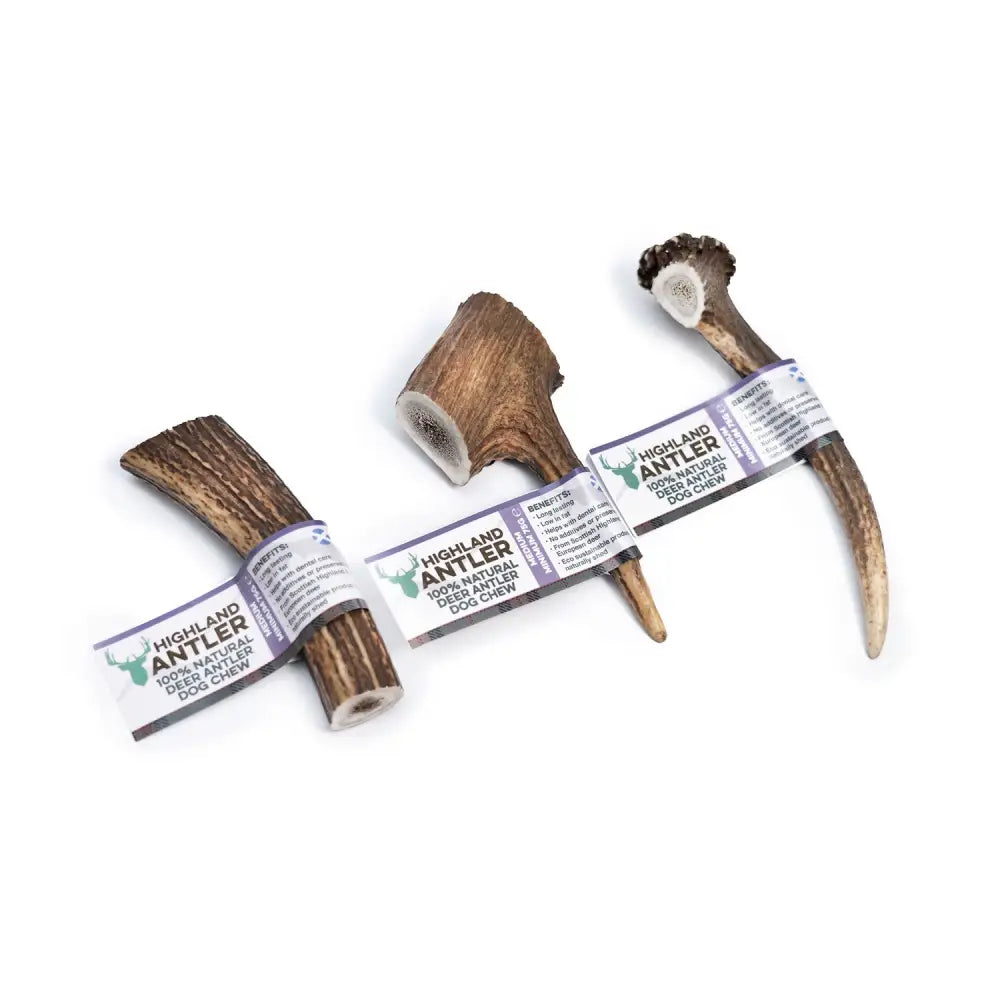 Three antos highland antler dog chews made from 100% natural deer antler in varied shapes and sizes with branded labels