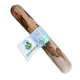 Natural olive wood dog chew toy with light brown and dark streaks wrapped in white label from antos origins olive branch dog