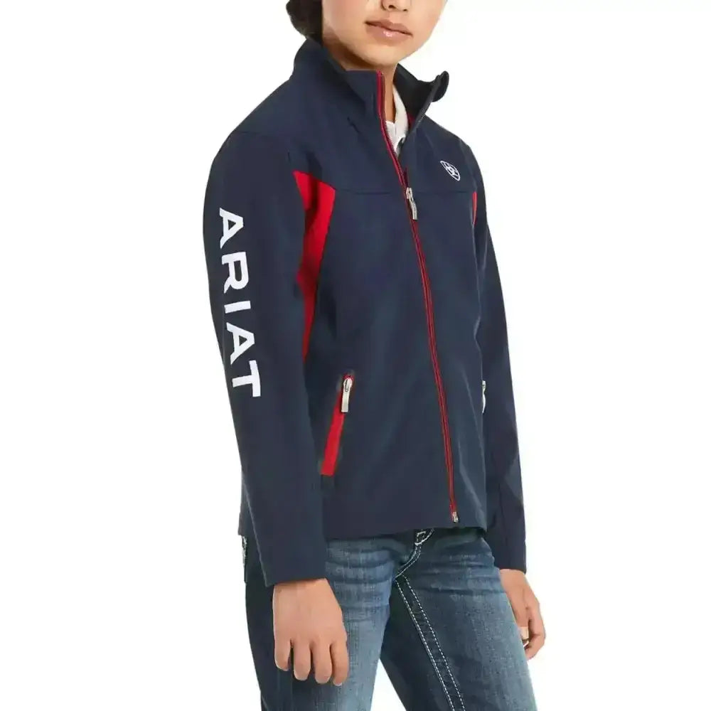 Navy blue ariat softshell jacket for kids with red zipper accents and white sleeve branding in colour block style