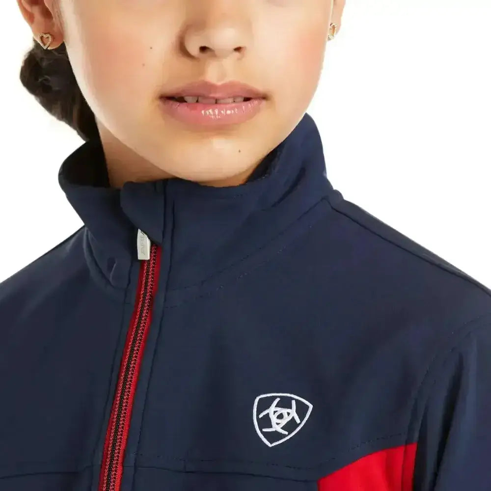 Kids ariat softshell jackets in navy blue and red colour block with white logo perfect for active play
