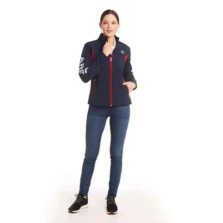 Navy blue and red ariat womans team softshell jacket with zip-up front and fierce colourblock styling with white sleeve lettering