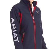 Navy blue ariat womans team softshell jacket with zip-up, red trim, white branding, and fierce colourblock styling