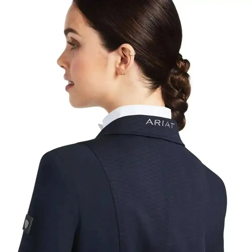 Back view of a navy blue ariat womens galatea show jacket with white collar and embroidered logo on neckline