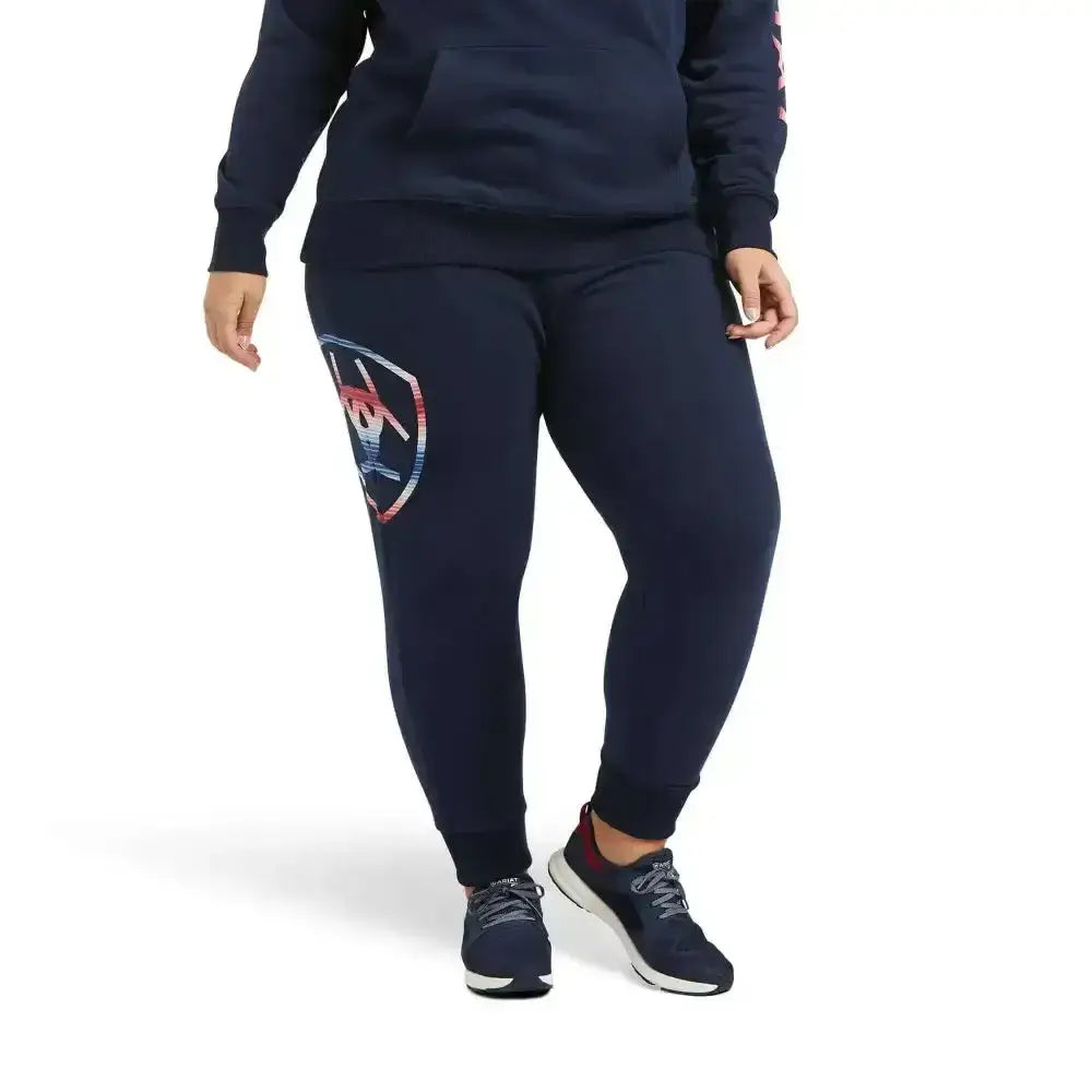Navy blue ariat jogger sweatpants with shield logo in red white and navy on left thigh perfect for casual wear