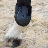 Black armoured guard pro protective hoof boot with glossy curved shell and elastic strap for protect compliant fetlock care