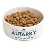 White ceramic dog food bowl with teal autarky complete dog food branding and running dog silhouette for adult chicken dog