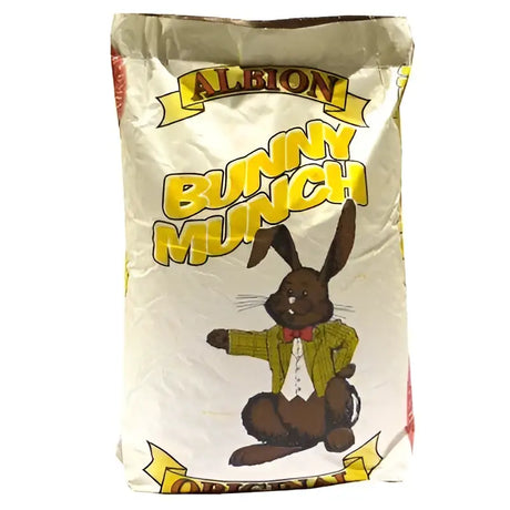 A bag of badminton albion bunny munch ultra chocolate candies with a cartoon bunny in a green sweater on white background