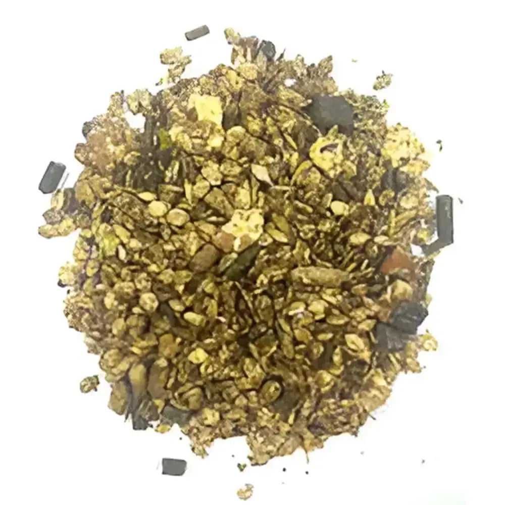 A pile of crushed gold flakes and dark mineral fragments from badminton country mix all-round smallholder ration feed