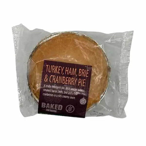 A baked to taste turkey ham brie cranberry pie in clear wrap with dark purple label perfect chunk squealer snack