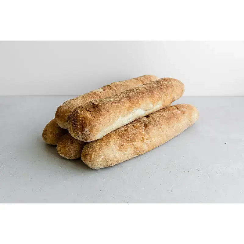 Golden-brown crusty baker tom ciabatta sticks with soft interior and flour-dusted surface ready to eat