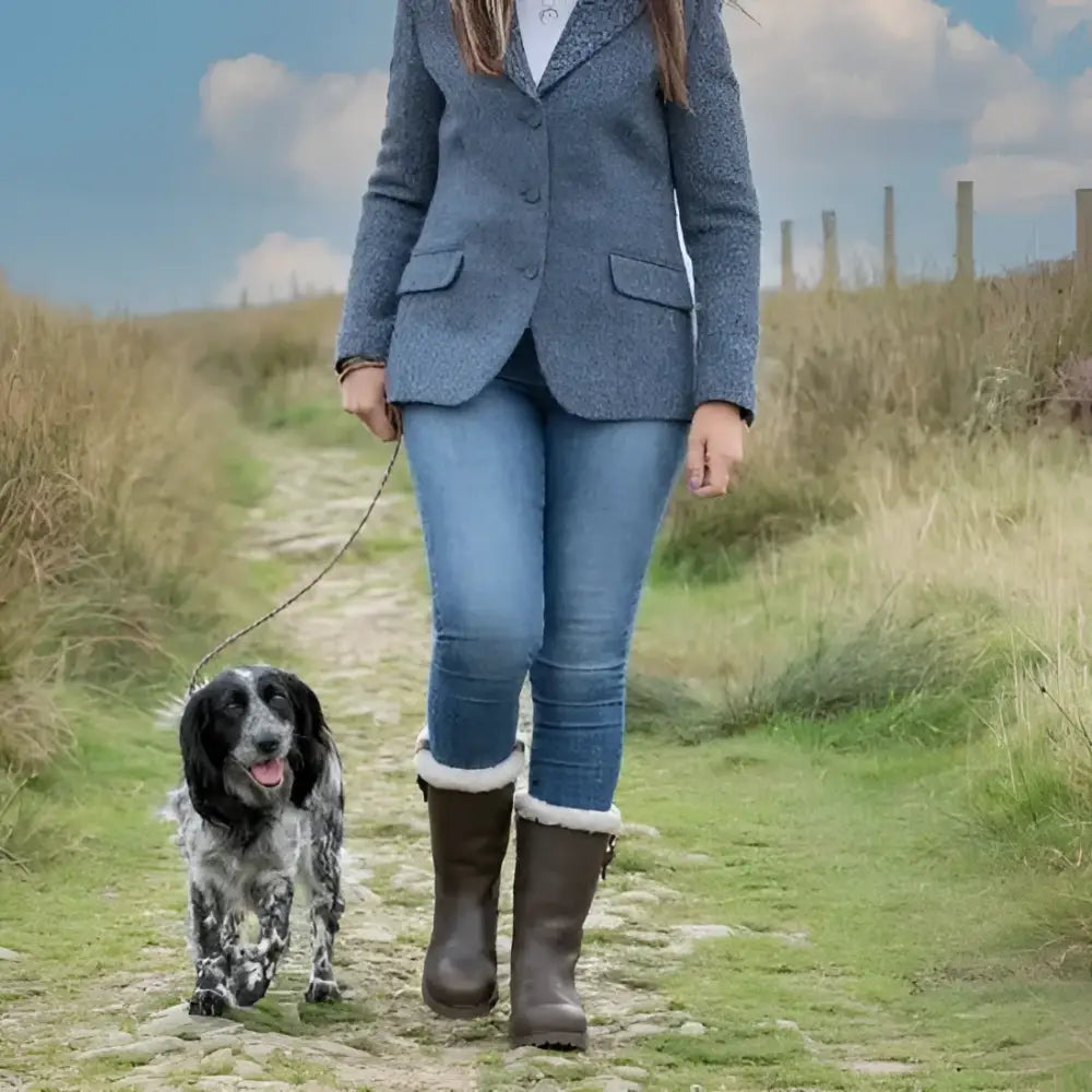 Woman wearing bareback footwear alaska storm waterproof brown boots with cosy sheep wool and white fur trim