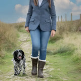 Woman wearing bareback footwear alaska storm waterproof brown boots with cosy sheep wool and white fur trim