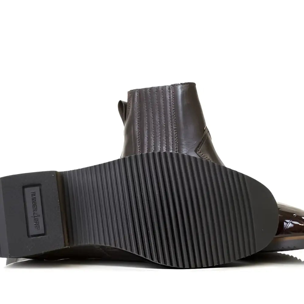 Dark brown leather ankle boot with ribbed vibram sole and visible stitching from bareback footwear monroe collection