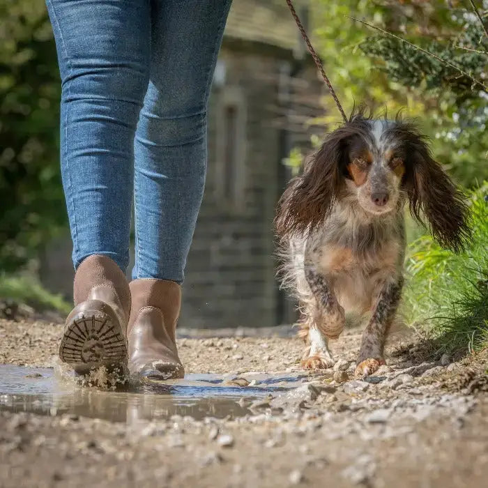 A wet muddy brown ankle boot from bareback footwear quebec waterproof with textured tread stormproof wil-tex sole