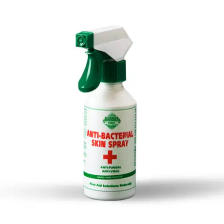 White plastic barrier anti-bacterial skin spray with green trigger for horse care featuring a red label and green cross