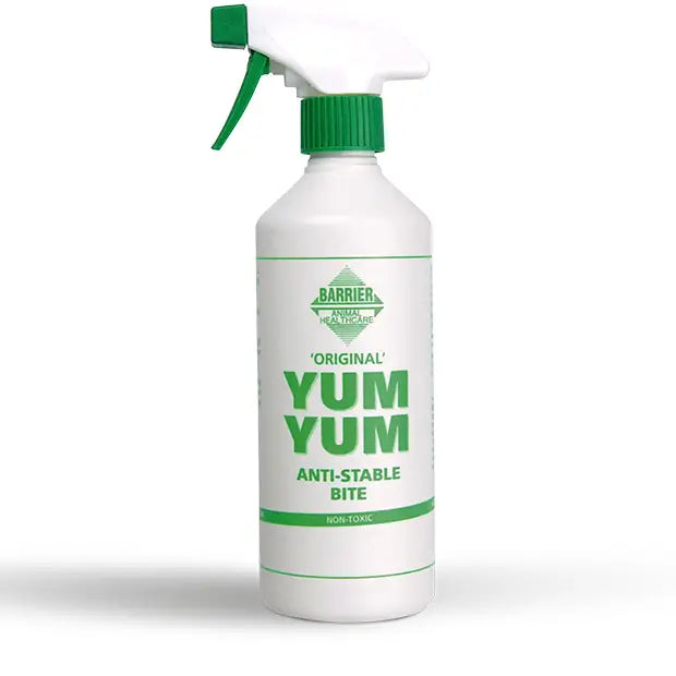 White plastic spray bottle with green trigger labeled barrier yum yum foul tasting spray to stop chewing instantly