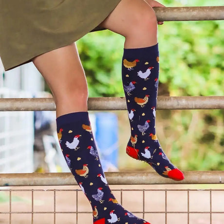 Dark blue funky welly socks for ladies with a colorful chicken pattern and bright red toe accents