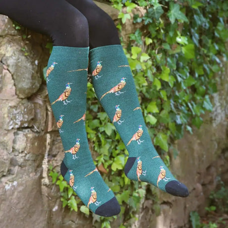 Teal green funky welly socks with black toe caps and a repeating ladies country pheasant pattern