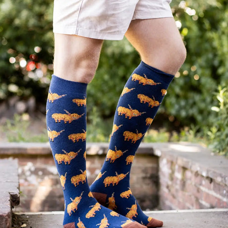 Navy blue bartleby funky funky welly socks with orange highland cows pattern hardy highland socks for men