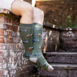 Olive green knee-high funky welly socks with blue and red vintage tractors from bartleby funky mens retro tractor line
