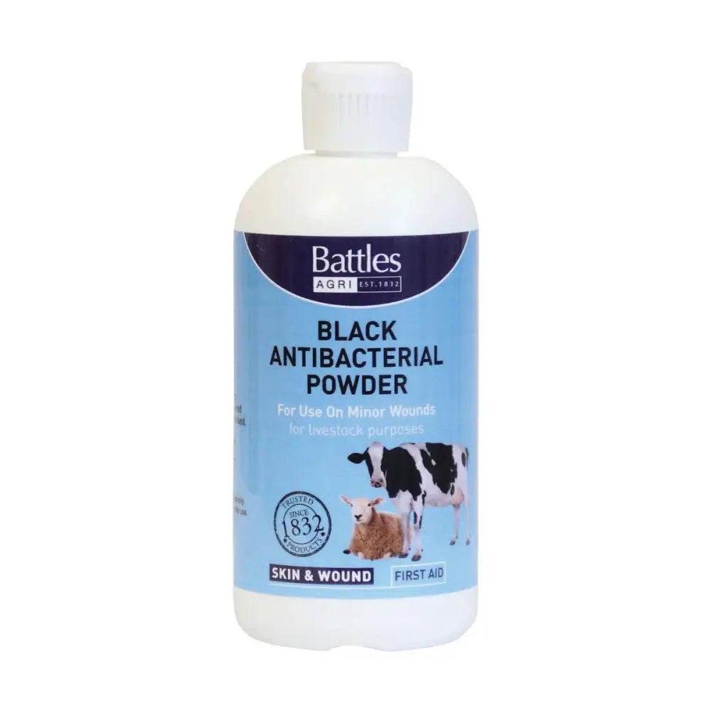 A white plastic bottle of battles black antibacterial powder with light blue label for minor wounds featuring cows illustration