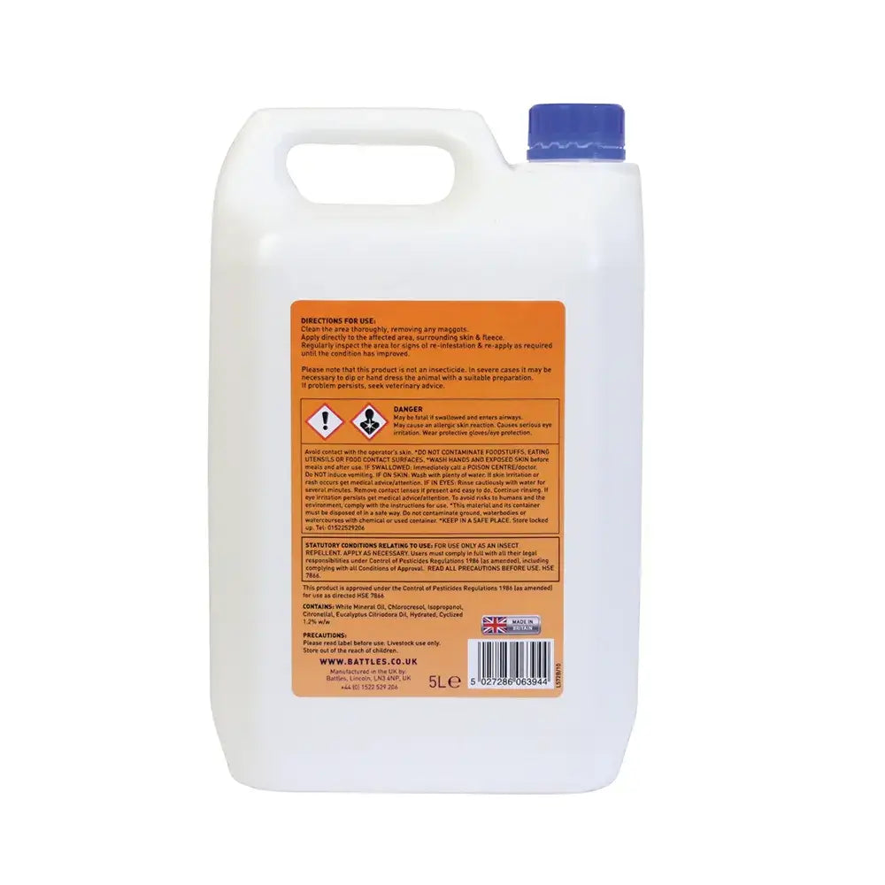 White plastic bottle with blue cap and orange label showing safety warnings of battles maggot oil soothing skin dressing for effective fly strike