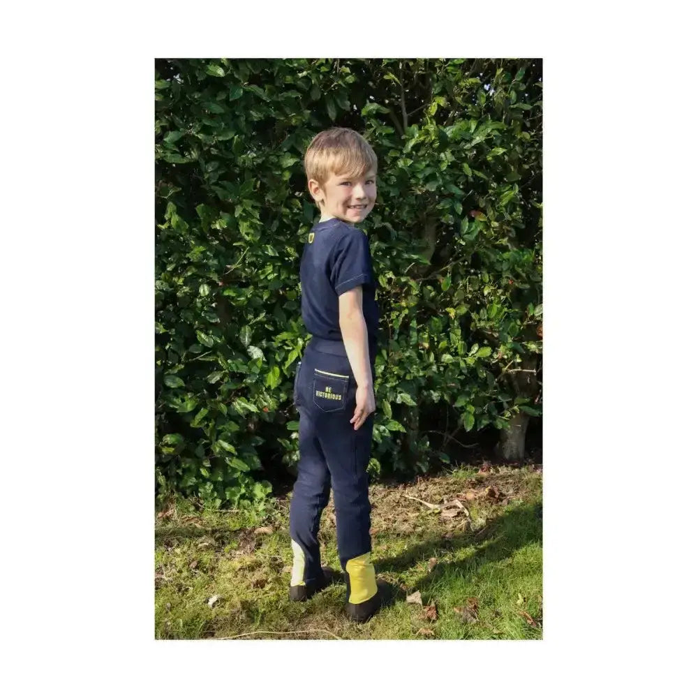 Back view of navy blue brave tots jodhpurs with yellow accents bulk elastic ankles and logo patch by little knight