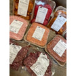 Packaged farm flavoured chicken in clear plastic with white label featuring black text and beeshill farm logo