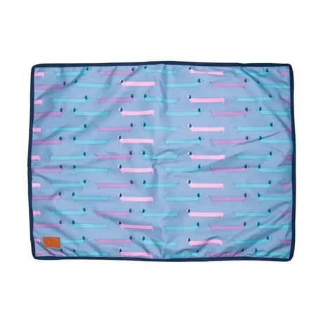 A light blue benji & flo dachshund dog bed with pink and teal dachshund pattern and navy trim from flo dorris