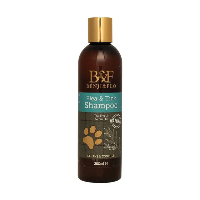 A dark amber glass bottle with gold cap and benji & flo label for equestrian flo flea and tick shampoo